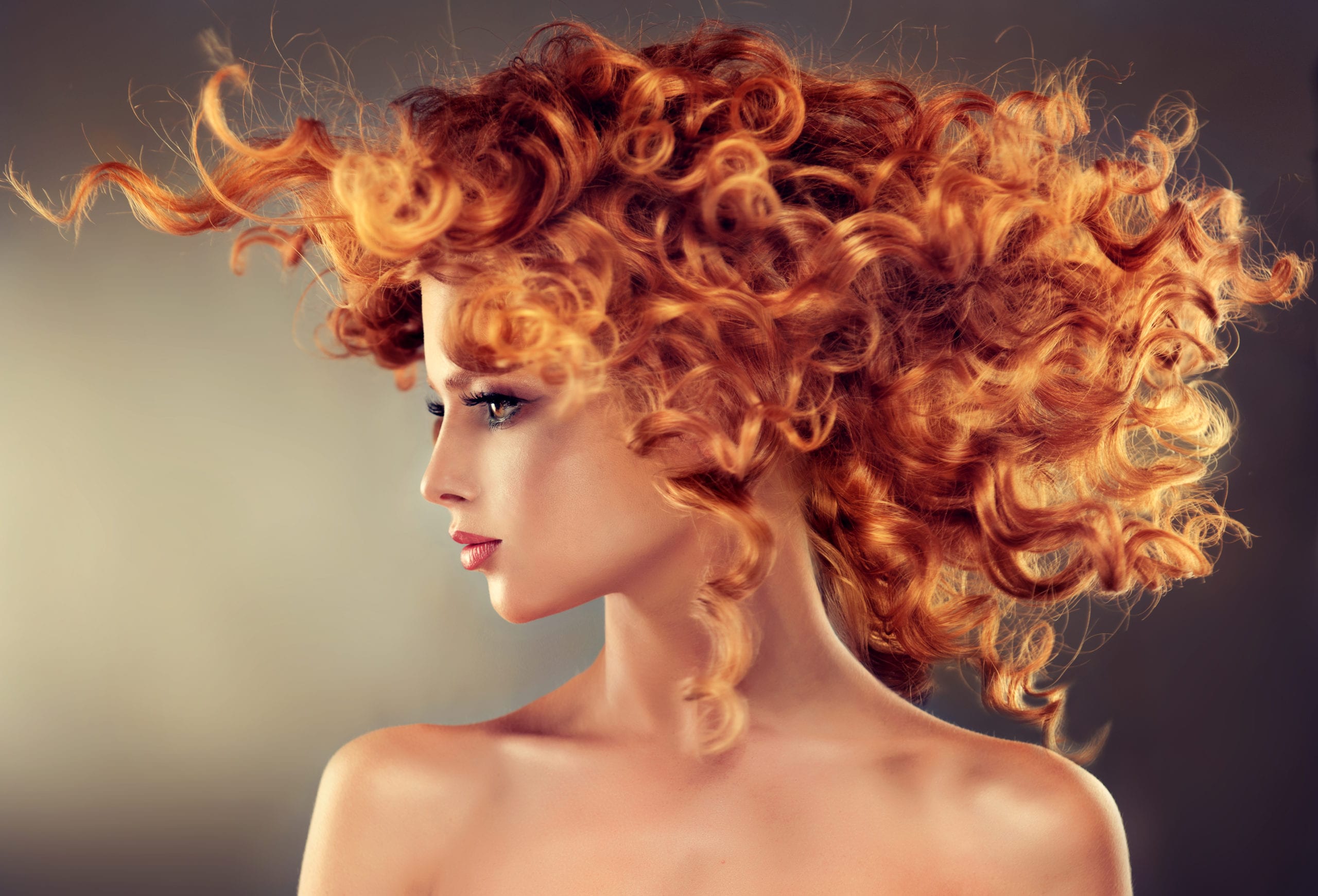 Pretty red haired girl with curly hairstyle. Pretty red haired girl with curly hairstyle.Flying hair in dynamic movement.